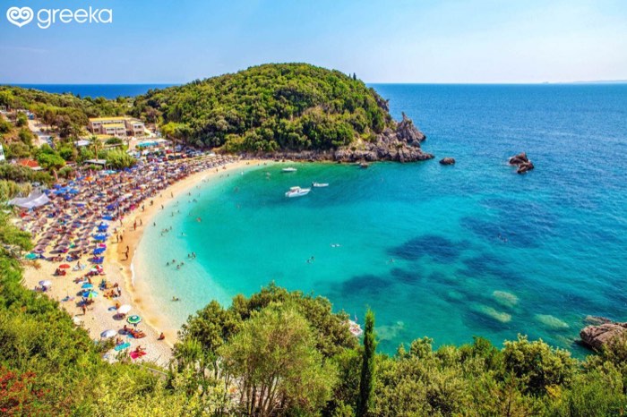 Sarakiniko beach near Agia, close to Parga, Greece — a small, sheltered turquoise bay backed by wooded hills.