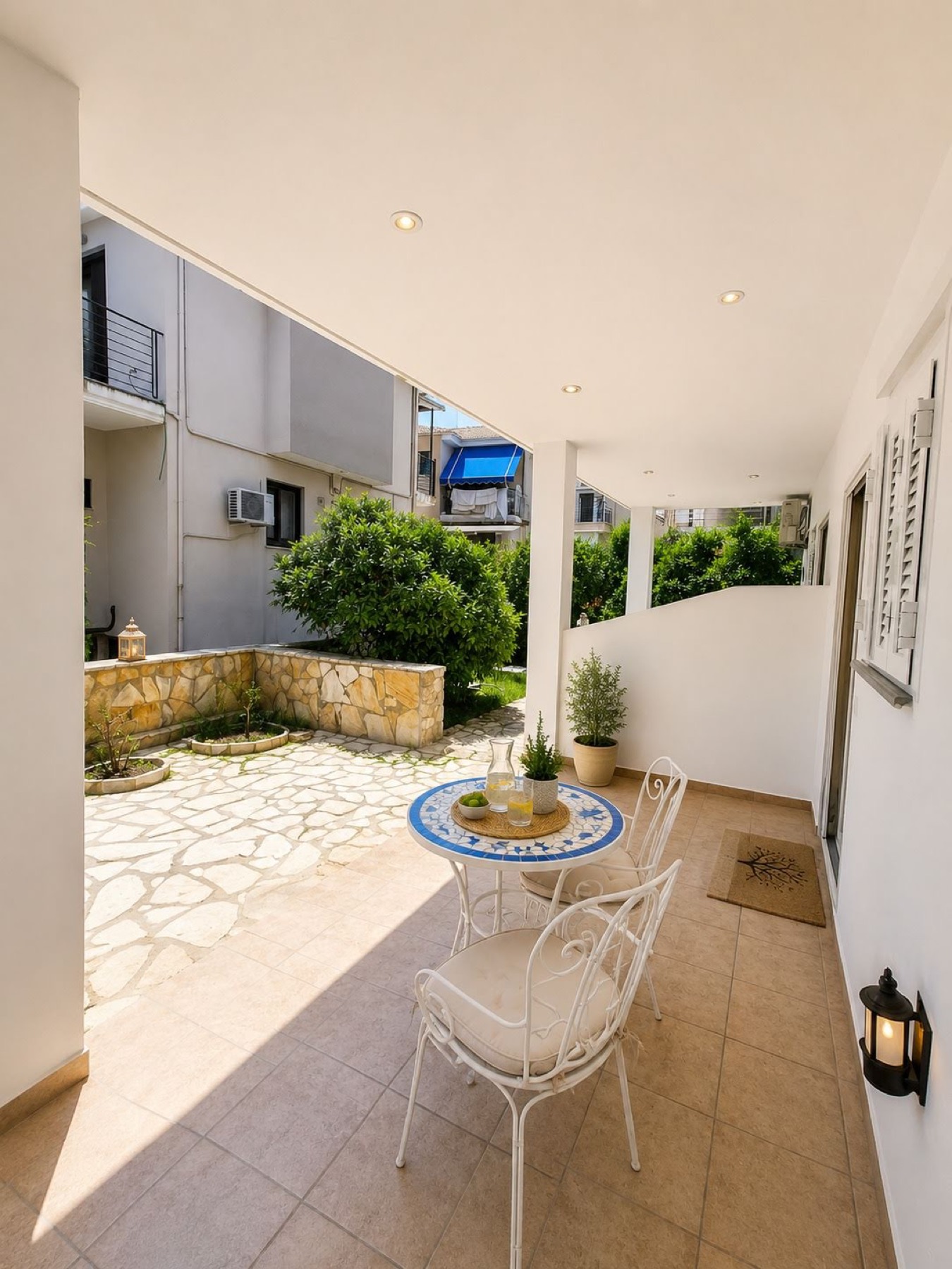 Private stone-paved garden veranda of the Olive Apartment