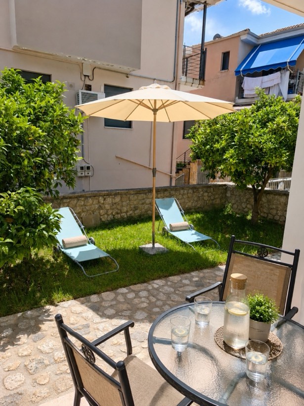 Private lawn with sun-loungers and parasol