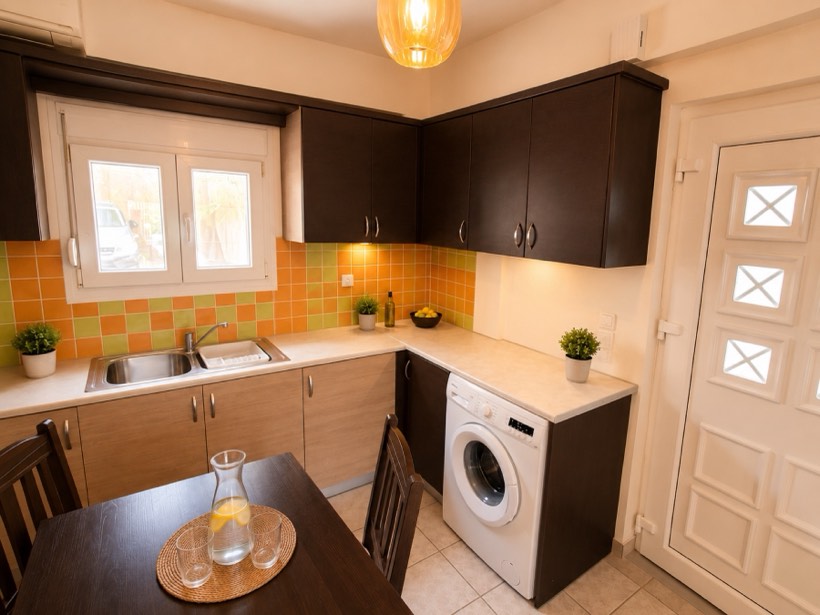Kitchen with washing machine and garden window