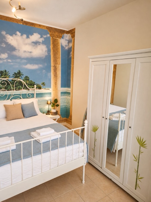 Double bed against the mural feature wall